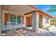 Inviting front porch with rocking chair, decorative brick pillar, and charming front door at 5216 W Beryl Ave, Glendale, AZ 85302