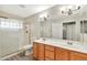 Bathroom features a large double vanity, a glass block walk-in shower and modern fixtures at 5249 E Shea Blvd # 214, Scottsdale, AZ 85254