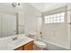 Standard bathroom featuring a sink, toilet, and bathtub/shower with glass block window at 5249 E Shea Blvd # 214, Scottsdale, AZ 85254