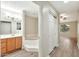 Bright bathroom with a soaking tub, vanity with tub, and closet at 5249 E Shea Blvd # 214, Scottsdale, AZ 85254