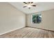 Inviting bedroom features a ceiling fan, neutral paint, plank flooring and a bright window at 5249 E Shea Blvd # 214, Scottsdale, AZ 85254