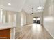 Bright living room with vaulted ceilings, ceiling fan, modern light fixture and sliding glass doors to balcony at 5249 E Shea Blvd # 214, Scottsdale, AZ 85254