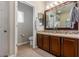 Double vanity bathroom featuring wood cabinets, a large mirror and carpeted floor at 5400 S Hardy Dr # 110, Tempe, AZ 85283