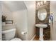 Charming half-bathroom with decorative wall, pedestal sink and tiled floor at 5400 S Hardy Dr # 110, Tempe, AZ 85283