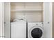 Convenient laundry closet equipped with a washer, dryer, and built-in shelving at 5400 S Hardy Dr # 110, Tempe, AZ 85283