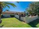 Serene backyard with a covered patio, lush lawn, and well-maintained garden, ideal for outdoor living and entertaining at 555 Leisure World --, Mesa, AZ 85206