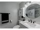 Bright bathroom with a large round mirror, stylish lighting, and white vanity at 555 Leisure World --, Mesa, AZ 85206