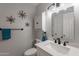 Updated bathroom featuring new vanity, white cabinets, black faucet, mirror and modern lighting at 555 Leisure World --, Mesa, AZ 85206