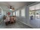 Bright dining area features a ceiling fan, windows with shutters, and access to the covered patio at 555 Leisure World --, Mesa, AZ 85206