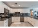 Well-lit kitchen with white cabinets, stainless steel appliances, and dark marble countertops at 555 Leisure World --, Mesa, AZ 85206