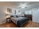 Cozy main bedroom features a ceiling fan, wood floors, and decor at 555 Leisure World --, Mesa, AZ 85206