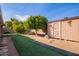 Spacious backyard featuring a shed, mature citrus trees, and artificial turf at 5618 E Des Moines St, Mesa, AZ 85205