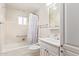 Bright bathroom featuring a shower/tub combo, white vanity, medicine cabinet, and neutral paint at 5618 E Des Moines St, Mesa, AZ 85205