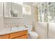 Small bathroom featuring wood vanity, a tiled shower, and a window with natural light at 5618 E Des Moines St, Mesa, AZ 85205