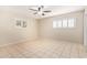 Bright bedroom with tile flooring, ceiling fan, and two windows providing natural light at 5618 E Des Moines St, Mesa, AZ 85205