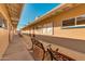 Exterior walkway featuring benches and access to community rooms like exercise, billiards, and workshop at 5618 E Des Moines St, Mesa, AZ 85205