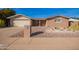 Charming single-story brick home featuring desert landscaping, attached garage, and covered entrance at 5618 E Des Moines St, Mesa, AZ 85205