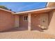 Covered front porch featuring brick flooring, a security door, and convenient access to the home at 5618 E Des Moines St, Mesa, AZ 85205