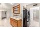 Traditional kitchen featuring tile flooring, honey colored wood cabinets, and a black refrigerator at 5618 E Des Moines St, Mesa, AZ 85205