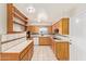 Traditional eat-in kitchen features tile countertops, a white dishwasher, and honey colored wood cabinetry at 5618 E Des Moines St, Mesa, AZ 85205