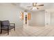 Inviting living room features tile floors, a modern ceiling fan, neutral paint, and bright natural light at 5618 E Des Moines St, Mesa, AZ 85205