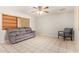 Living room boasts tile floors, neutral walls, a ceiling fan, and a cozy seating area at 5618 E Des Moines St, Mesa, AZ 85205