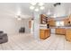 View of open floor plan, connecting living, dining, and kitchen areas with tile flooring and neutral tones at 5618 E Des Moines St, Mesa, AZ 85205