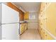 Spacious utility room featuring lots of cabinets, a utility sink, and tiled flooring at 5618 E Des Moines St, Mesa, AZ 85205