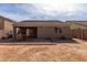 A spacious backyard features a covered patio, offering a canvas for personalized landscaping and relaxation at 562 W Enchanted Desert Dr, Casa Grande, AZ 85122