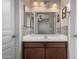 Bathroom vanity featuring a sink, wood cabinet, and a mirror with lighting at 562 W Enchanted Desert Dr, Casa Grande, AZ 85122