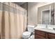 Bathroom featuring a toilet, sink, and a shower with a patterned curtain at 562 W Enchanted Desert Dr, Casa Grande, AZ 85122