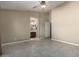 A spacious bedroom with neutral-colored walls, tiled floor, and a view into the bathroom at 562 W Enchanted Desert Dr, Casa Grande, AZ 85122