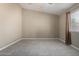 Simple bedroom featuring tile floors, neutral walls, and a window with natural light at 562 W Enchanted Desert Dr, Casa Grande, AZ 85122