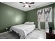 Bedroom with green walls, a ceiling fan, and a bed with a decorative quilt at 562 W Enchanted Desert Dr, Casa Grande, AZ 85122