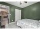 A bedroom with green walls, a view into the hallway and closet with white doors at 562 W Enchanted Desert Dr, Casa Grande, AZ 85122