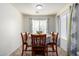 Well-lit dining room featuring tile floors, a large window, and seating for six at 562 W Enchanted Desert Dr, Casa Grande, AZ 85122