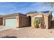 View of a single story house featuring xeriscaping and solar panels on the roof at 562 W Enchanted Desert Dr, Casa Grande, AZ 85122