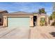 Charming single-story home featuring a green garage door and desert landscaping at 562 W Enchanted Desert Dr, Casa Grande, AZ 85122