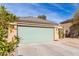 Well-maintained home with xeriscaping, a concrete driveway and a green garage door at 562 W Enchanted Desert Dr, Casa Grande, AZ 85122