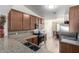 Bright kitchen with granite countertops, stainless steel appliances, and a view of the dining area at 562 W Enchanted Desert Dr, Casa Grande, AZ 85122