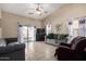 Bright living room featuring tile floors, a ceiling fan and sliding glass doors at 562 W Enchanted Desert Dr, Casa Grande, AZ 85122