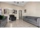 Cozy living room featuring tile floors, neutral walls, and comfortable gray furniture at 562 W Enchanted Desert Dr, Casa Grande, AZ 85122