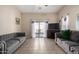 Bright living room featuring tile floors, a ceiling fan and sliding glass doors at 562 W Enchanted Desert Dr, Casa Grande, AZ 85122