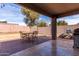 Relaxing covered patio area with stylish tile flooring and ample space for outdoor furniture at 562 W Enchanted Desert Dr, Casa Grande, AZ 85122