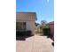 View of the backyard with concrete patio, tiled roof, and gravel pathway to a storage shed at 5624 E Garnet Ave, Mesa, AZ 85206