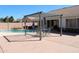 Backyard patio features a pergola with outdoor seating and an umbrella, and a pool at 5624 E Garnet Ave, Mesa, AZ 85206