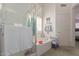 Bright bathroom features a glass shower, soaking tub, and towel storage at 5624 E Garnet Ave, Mesa, AZ 85206