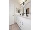 Clean bathroom with double vanity, modern fixtures, framed mirror, and tiled floor at 5624 E Garnet Ave, Mesa, AZ 85206