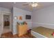 Cozy bedroom with wood floors, ceiling fan, wall-mounted TV and dresser at 5624 E Garnet Ave, Mesa, AZ 85206