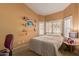 Comfortable bedroom with window shutters and small decorative shelving at 5624 E Garnet Ave, Mesa, AZ 85206